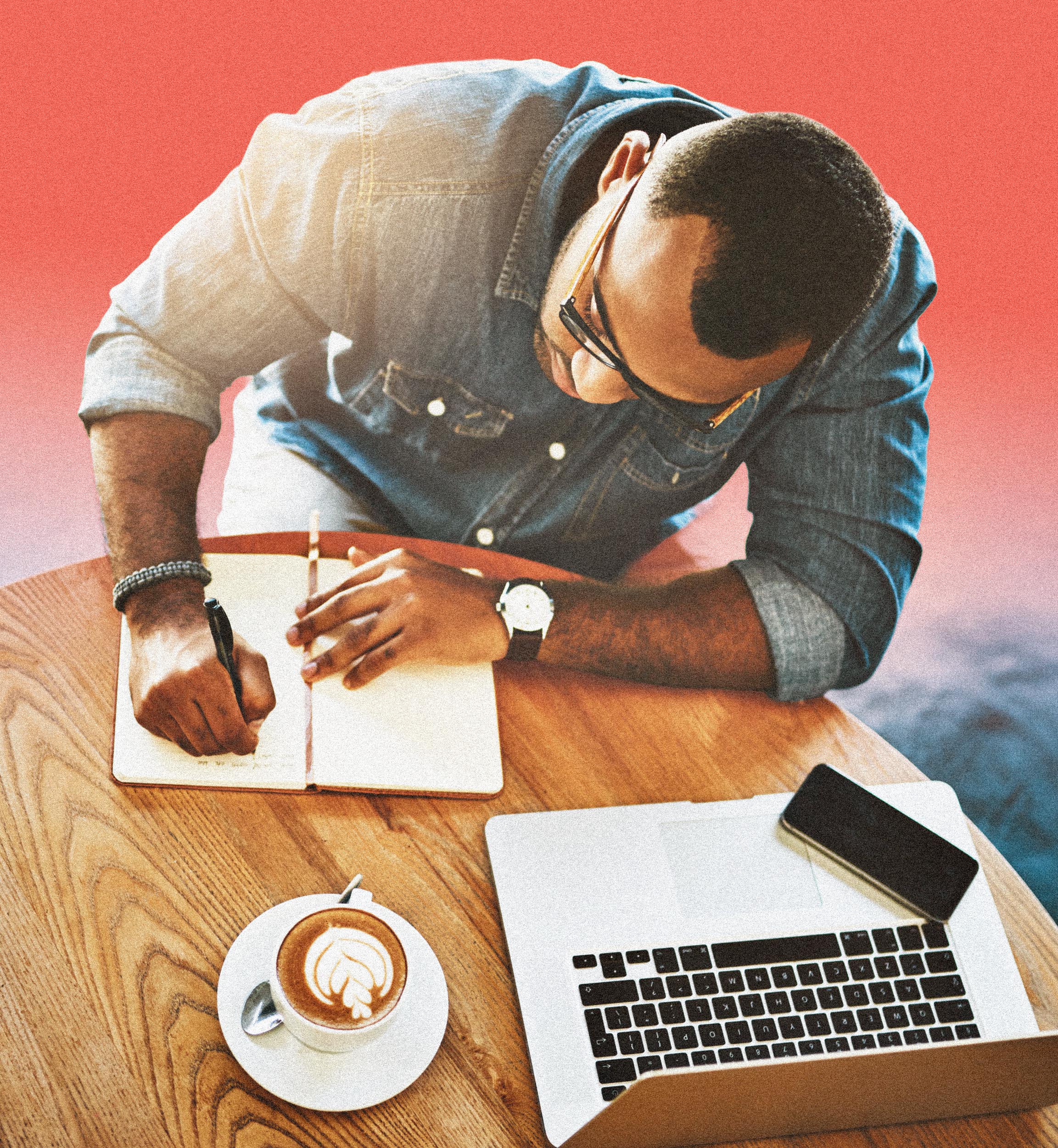 A writer drafting by hand at a cafe table